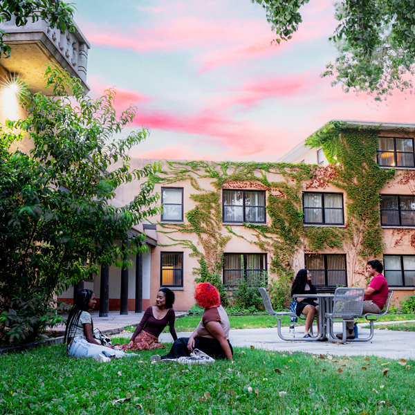 Students relaxing in Hokona courtyard during sunset