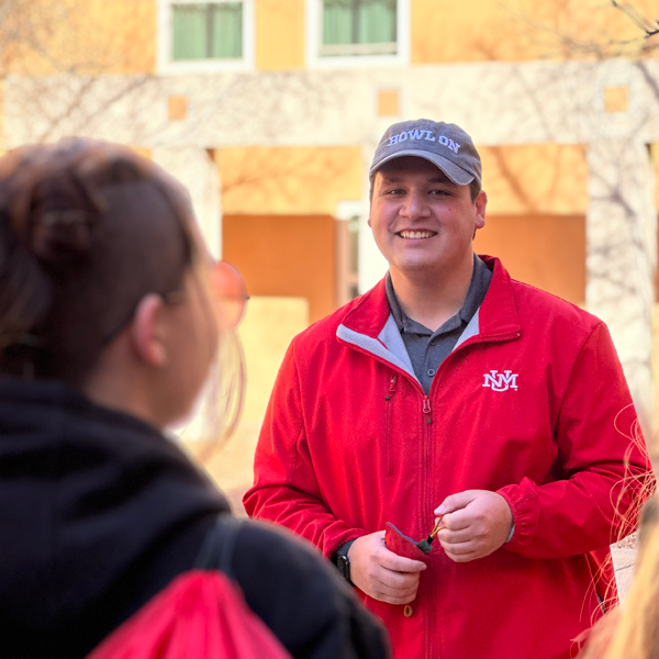 smiling tour guide in UNM gear