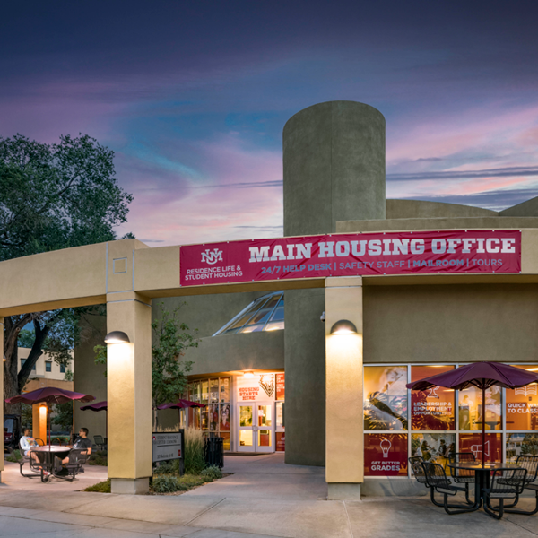 Evening photo of SRC Commons with two students sitting in front